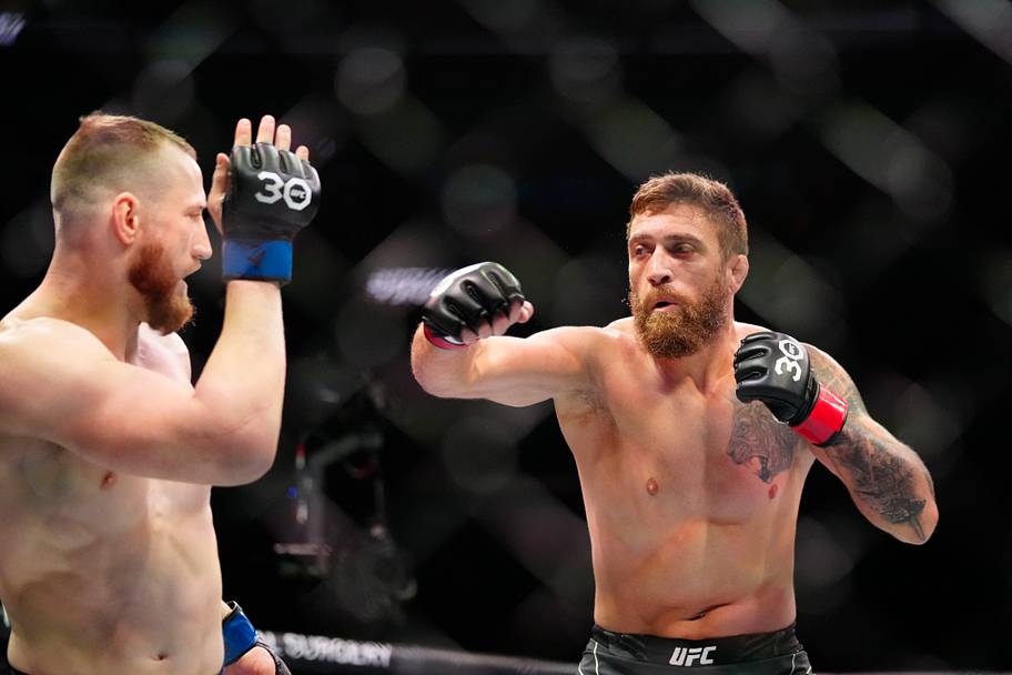 Gerald Meerschaert (red gloves) fights Joe Pyfer (blue gloves) during UFC 287 at Miami-Dade Arena.