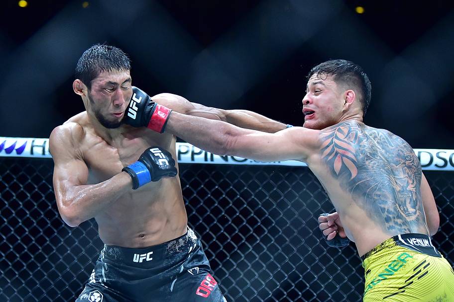 Elves Brener (red gloves) fights Myktybek Orolbai (blue gloves) during UFC 301 at Rio Arena.