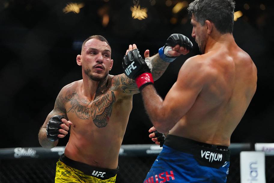 Beneil Dariush (red gloves) fights Renato Moicano (blue gloves) during UFC 317 at T-Mobile Arena.