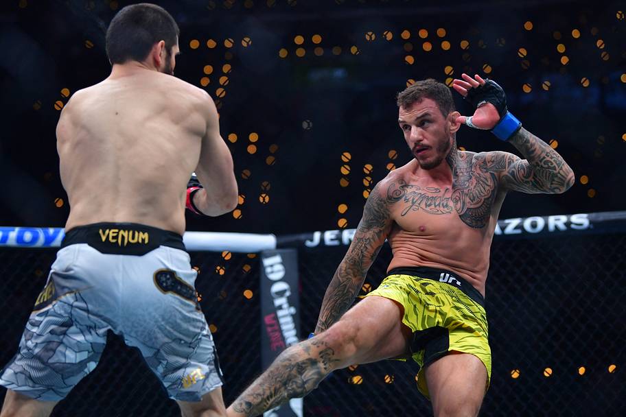 Islam Makhachev (red gloves) fights Renato Moicano (blue gloves) in a lightweight title fight during UFC 311 at Intuit Dome.