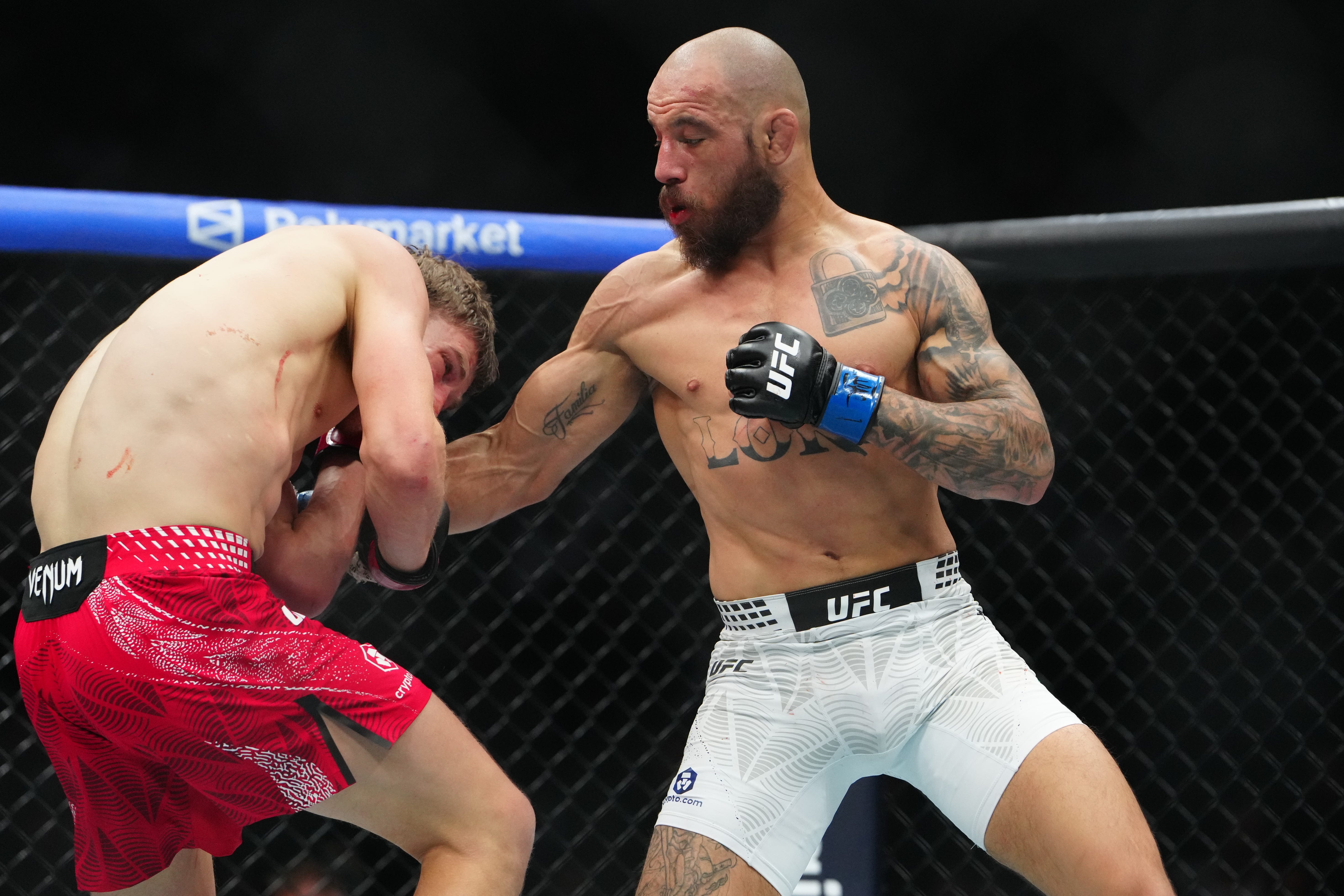 Jan 24, 2026; Las Vegas, Nevada, USA; Arnold Allen (red gloves) fights Jean Silva (blue gloves) during UFC 324 at T-Mobile Arena. Mandatory Credit: Stephen R. Sylvanie-Imagn Images