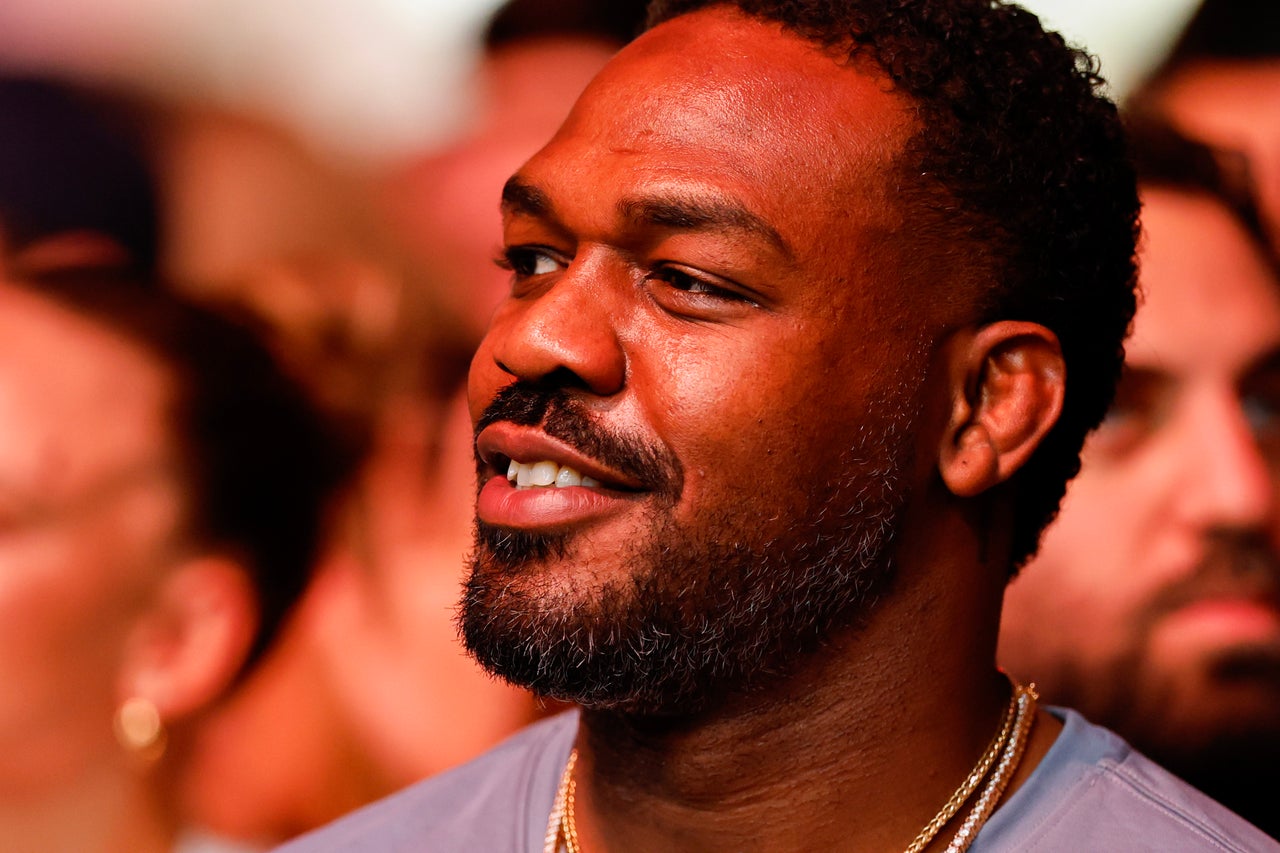 Jon Jones sitting cageside at UFC 327 in April (Getty)