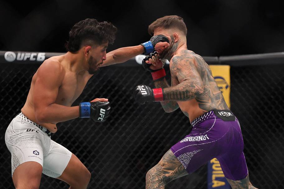 Cody Garbrandt (red gloves) fights Adrian Yanez (blue gloves) in a bantamweight bout during UFC 329 at T-Mobile Arena.