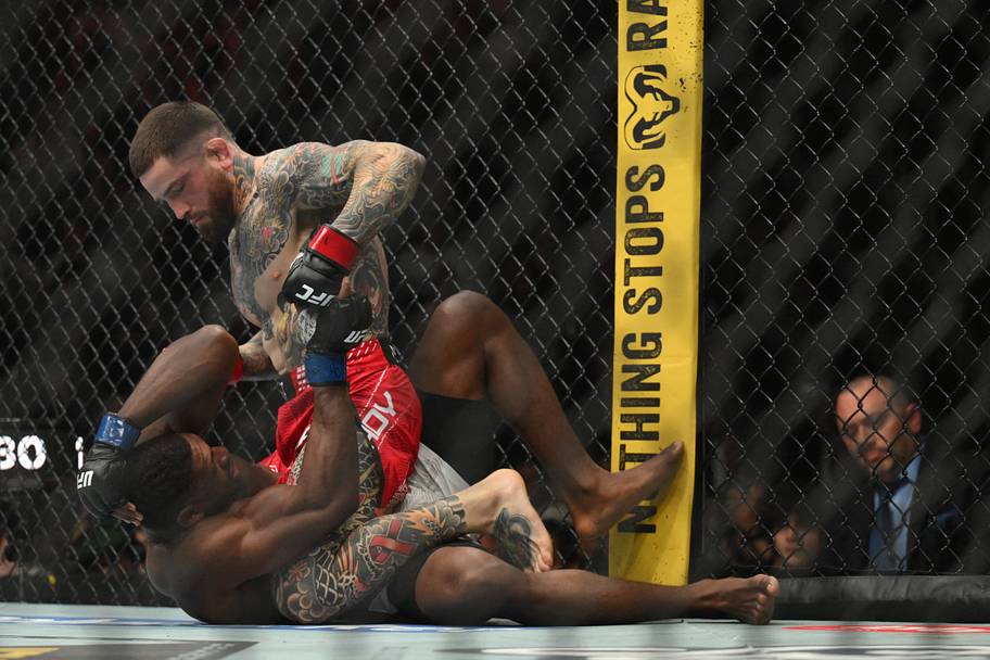Sean Brady (red gloves) fights Joaquin Buckley (blue gloves) during UFC 328 at Prudential Center.