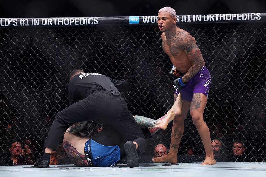 Michael Morales (blue gloves) reacts after defeating Sean Brady (red gloves) in the welterweight bout during UFC 322 at Madis
