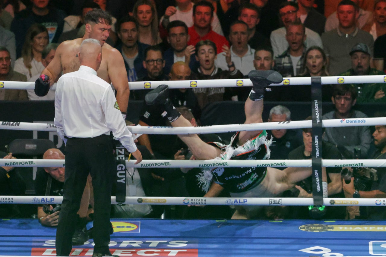 Carty tumbling out of the ring in round one (AP)