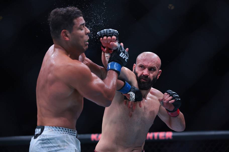 Azamat Murzakanov (red gloves) fights Paulo Costa (blue gloves) during UFC 327 at Kaseya Center.